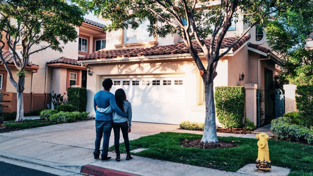 Home prices top reasons homeowners stay put, survey finds